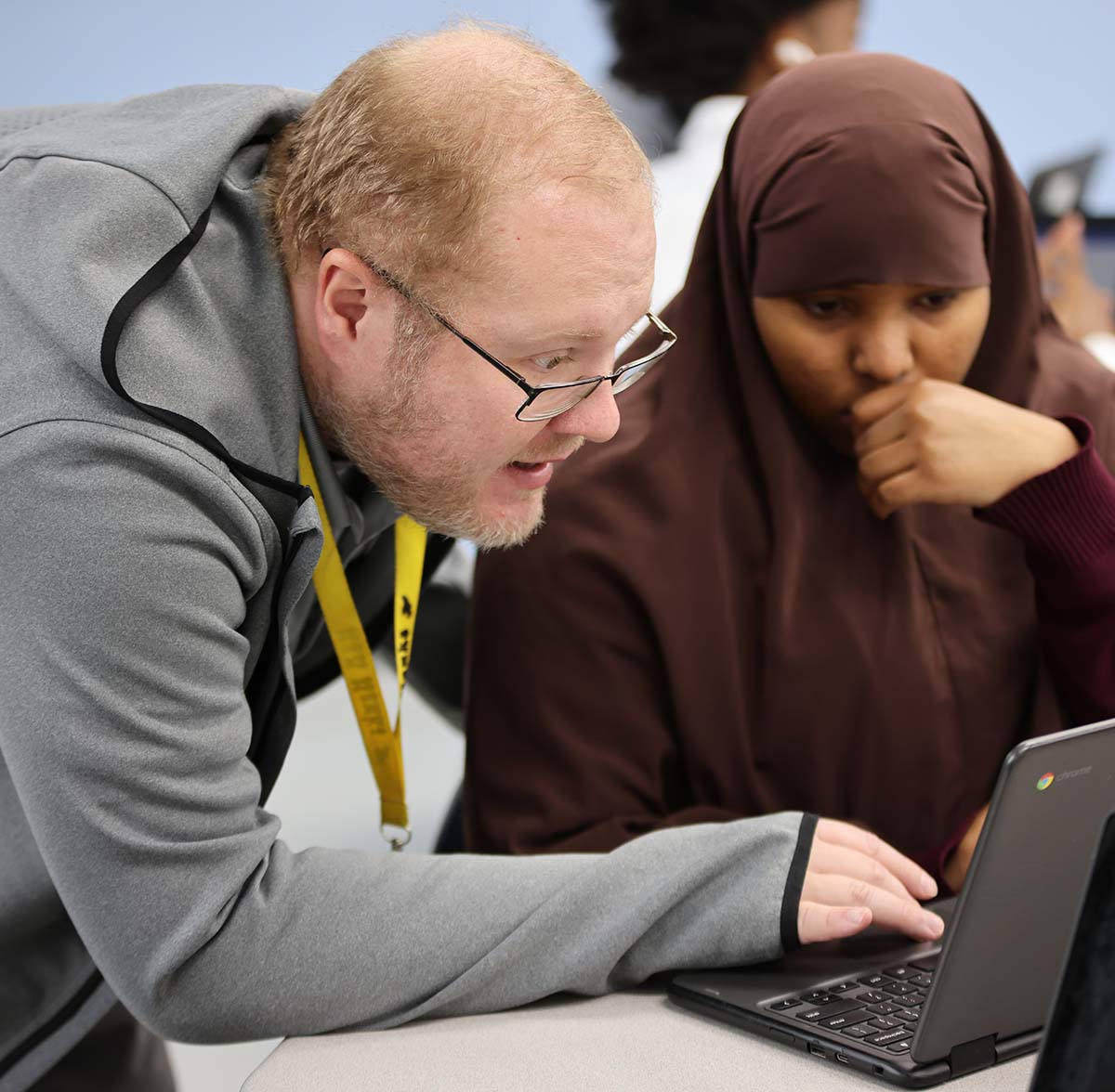 Horizon Science Academy Teacher and student interacting at a classroom desk