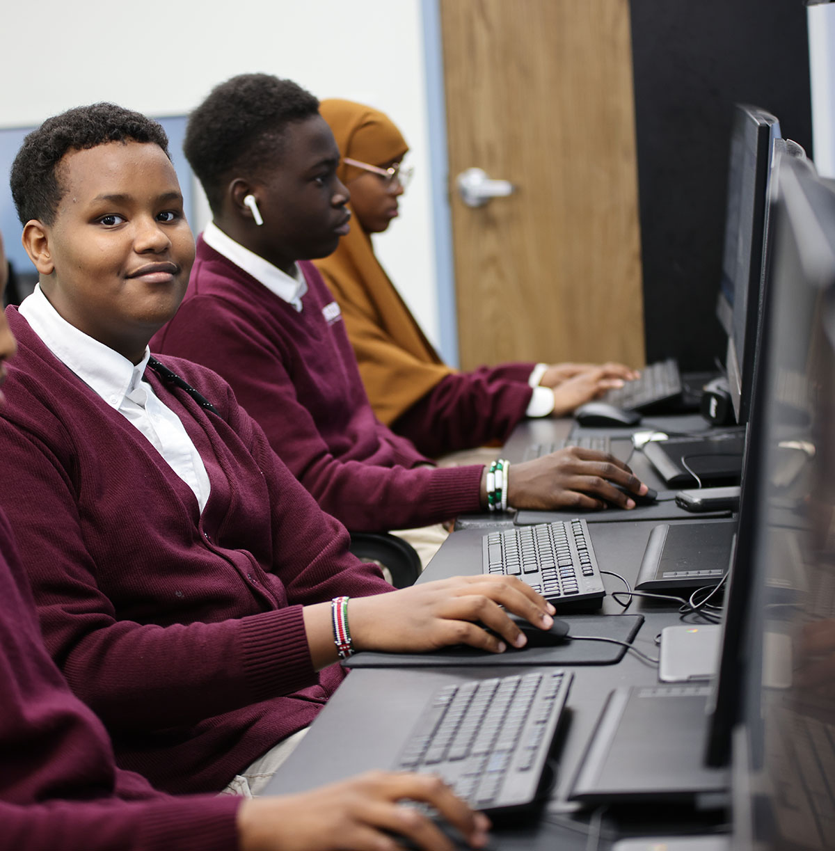 Student drawing in a classroom.